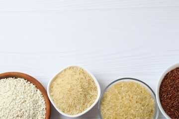 Different types of rice in bowls on table, closeup