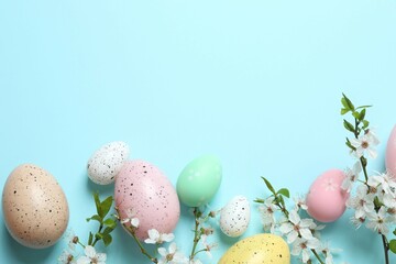 Happy Easter. Colorful eggs and white spring flowers on color background, space for text or advertising