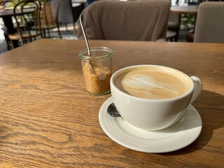 Cup of aromatic cappuccino on a table in a cafe