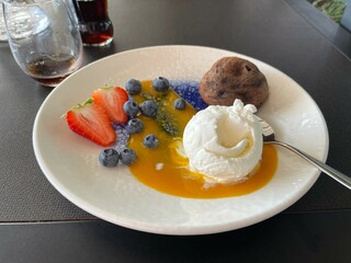 Chocolate fondant on a plate with berries, ice cream and mousse