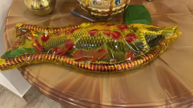Fish made from sweets is covered with decorating paper in Bengali wedding.