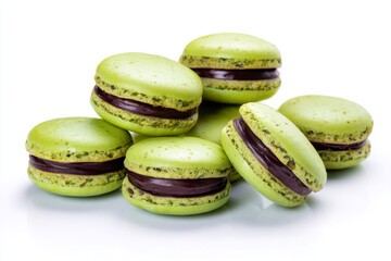 Green macarons with chocolate filling are artfully arranged on white background, showcasing their vibrant color and tempting appearance