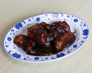 Barbecue pork ribs served on white and blue plate for meat lover and comfort food concepts