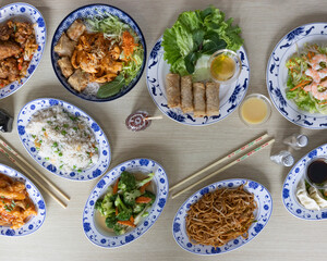 Asian food buffet with noodles, rice, spring rolls and vegetables for restaurant and delivery menu visuals