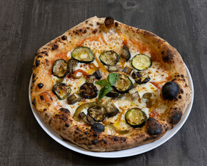 Vegetarian pizza with grilled zucchini, eggplant and peppers for healthy Italian food visuals