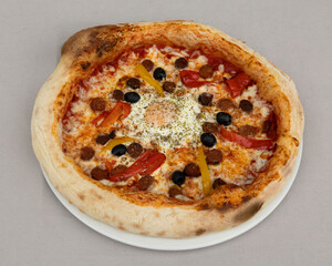 Spicy chorizo pizza with black olives and red peppers for bold Italian-Spanish fusion visuals