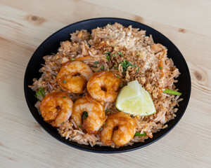 Spicy rice with grilled shrimp and lemon wedge for West African or Caribbean food visuals