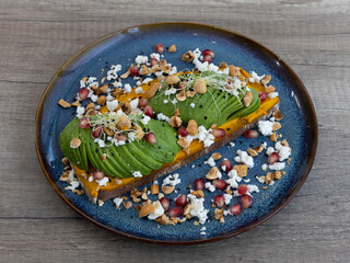 Avocado toast with pomegranate and seeds for healthy breakfast and wellness food visuals