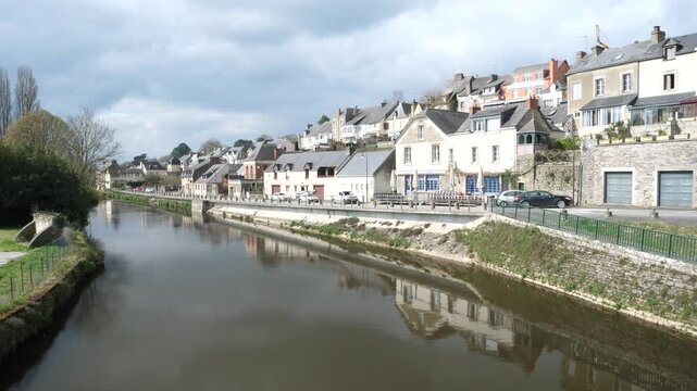 A view of the Oust river and the Josselin city of Josselin in the background. Josselin, France - March 26, 2025. 