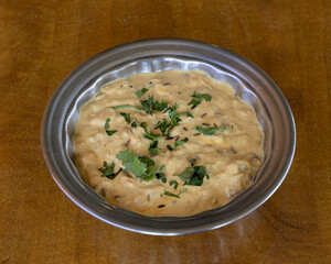 Creamy Indian curry served in metal bowl for authentic home-cooked food visuals