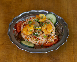 Indian prawn rice with vegetables and cucumber slices for seafood and traditional cuisine visuals