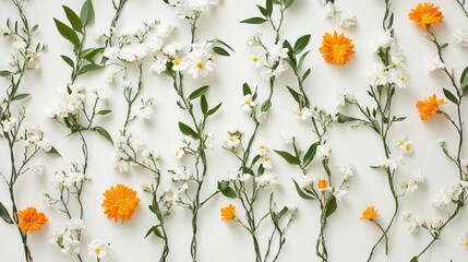 Decorative garlands of marigold and jasmine spread out on white surface