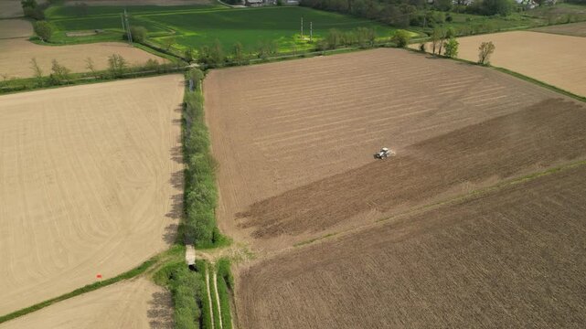 Aerial View of Cultivated Fields: A bird's-eye perspective unveils a patchwork of agricultural fields in various stages of cultivation, showcasing the meticulous patterns of modern farming practices.