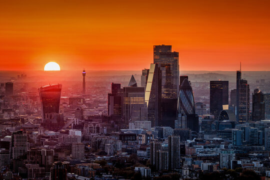 Elevated view of a fiery sunset behind the urban skyline of the City of London, England
