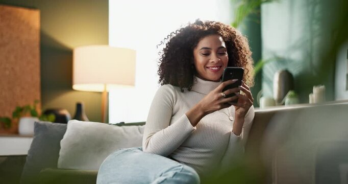 Happy woman, typing and relax with phone on sofa for social media, browsing or reading news at home. Female person with smile on mobile smartphone for online chatting, texting or scrolling at house