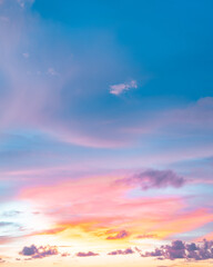 Stunning sunset with colorful clouds painted in pink and orange against a soft blue backdrop.