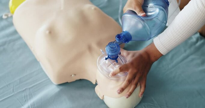 Ventilator, cpr and above of person with dummy for demonstration, tutorial and lesson for first aid. Healthcare, safety and woman with respiratory mask for paramedic course, learning or medical class