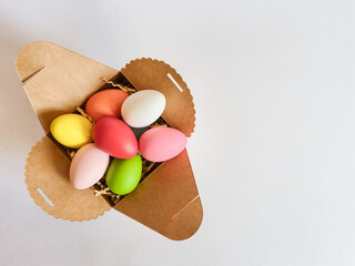 A box brimming with colorful Easter eggs on a white background