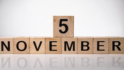 Minimalist photo of wooden blocks with date 5 November. Day and month, calendar on white background