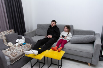 Siblings enjoy gaming in a cozy living room during a peaceful evening together, sharing laughter and thrilling moments on their favorite console