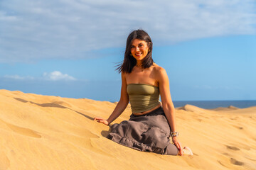 Tourist enjoying relaxing sunny day at maspalomas dunes in gran canaria