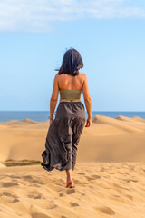 Tourist walking on maspalomas dunes in gran canaria, spain