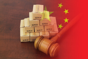Wooden gavel with many cardboard boxes and flag of China. Chinese import tariffs concept.	