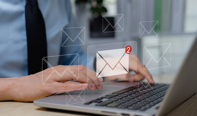 Businessman using laptop with email in virtual reality, email notification concept, direct selling project in email customer list business and email marketing concept.