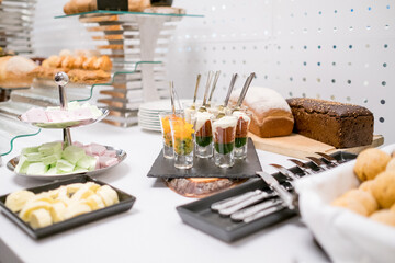 There is a wide variety of different types of delicious food available on the table for everyone to enjoy and explore