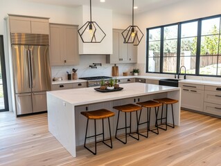 Fototapeta premium Bright kitchen featuring a large island, quartz countertops, barstools, stainless steel fridge, and modern pendant lights. 