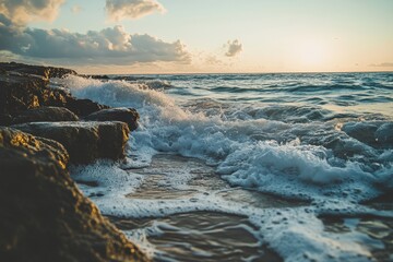 Coastal waves crash against rocks at sunrise