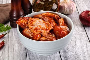 Raw marinated buffalo chicken wings