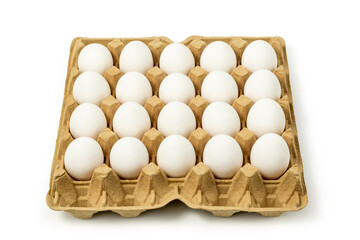 Top view of white chicken eggs in the cardboard egg tray with rooms for twenty eggs isolated on white background, with clipping path included