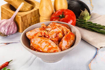 Raw marinated uncooked chicken wings