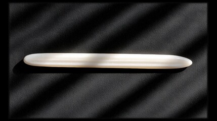 A white crystal ball rests on a black surface.