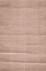 Fototapeta premium High-resolution texture of folded brown recycled paper. The image features a grid of symmetrical square folds, creating a tactile and geometric surface. The rough fiber texture adds a natural feel.