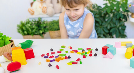 Fototapeta premium Child with jelly candies. Selective focus.