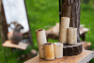 Candles on wooden log, nature background .