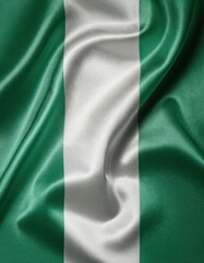 Obraz premium Waving flag of nigeria with green and white vertical stripes on silk fabric