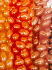 Colorful assortment of jelly beans collected in a clear container for candy lovers to enjoy