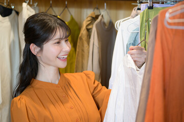 クローゼットで服を選ぶ日本人女性