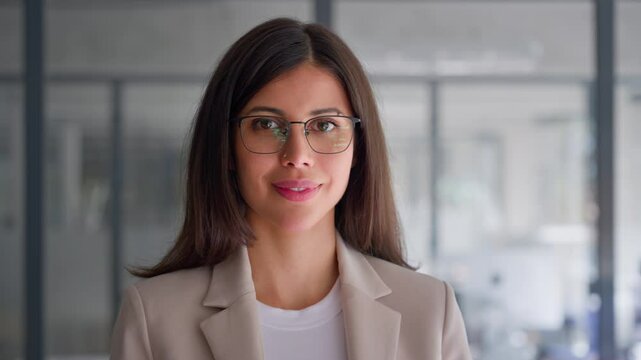 Closeup portrait of middle age leader adult executive CEO entrepreneur businesswoman. Headshot of beautiful smiling latin hispanic, middle eastern business woman standing in office looking at camera
