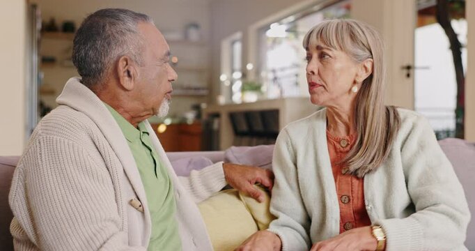 Shout, frustrated and senior people angry from argument, fight or disagreement on sofa in living room, house or retirement home. Elderly female person, mature man or couple with difference of opinion