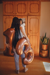 The girl holds the numbers 1 and 3 behind her back