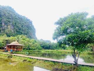 Fototapeta premium Lake and mountain. Karst mountain. Rammang Rammang Karst Mountain. landscape of Ramang-Ramang, a geological site, one of the biggest karst in the world. 