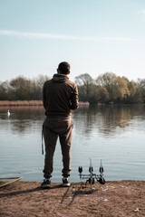 Carp fishing on a lake, fisherman angling scene
