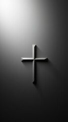Black cross on a gray wall with sunlight shining from behind.