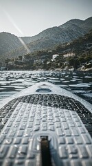 Paddleboard perspective: scenic lake adventure with sunlit mountains
