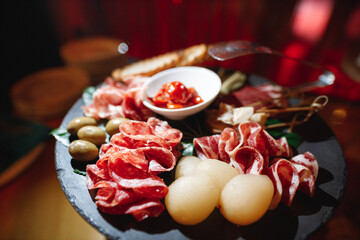 A delightful plate filled with a variety of meats and fresh vegetables is beautifully arranged on a table, creating an appetizing sight