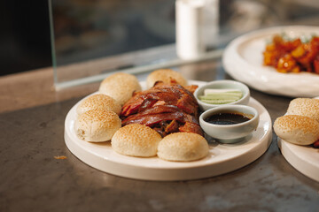 A delectable plate of food featuring a variety of bread accompanied by a flavorful sauce set elegantly on a wellarranged dining table